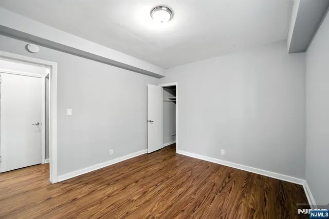 a view of room with wooden floor