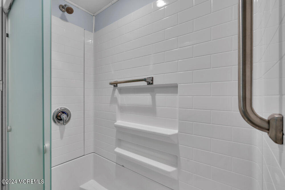 95 Solar Drive Brick, NJ 08724 - Photo 18 of 35 a bathroom with a glass shower door