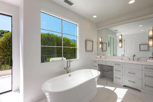 a bathroom with a tub sink and window