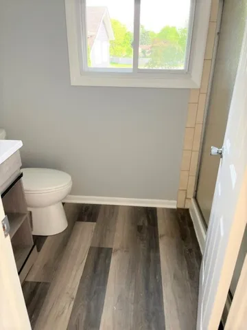 a bathroom with a toilet and a window