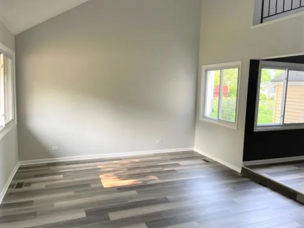 a room with a window and wooden floor