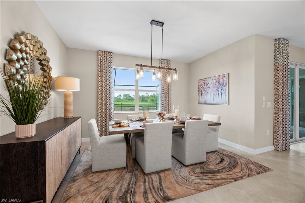 20790 Copperhead Drive Lehigh Acres, FL 33936 - Photo 21 of 36 a dining room with wooden floor and a chandelier