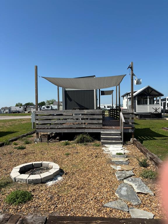 6397 Peninsula Road, Unit 132 Kerens, TX 75144 - Photo 4 of 15 a backyard of a house with barbeque oven and outdoor seating