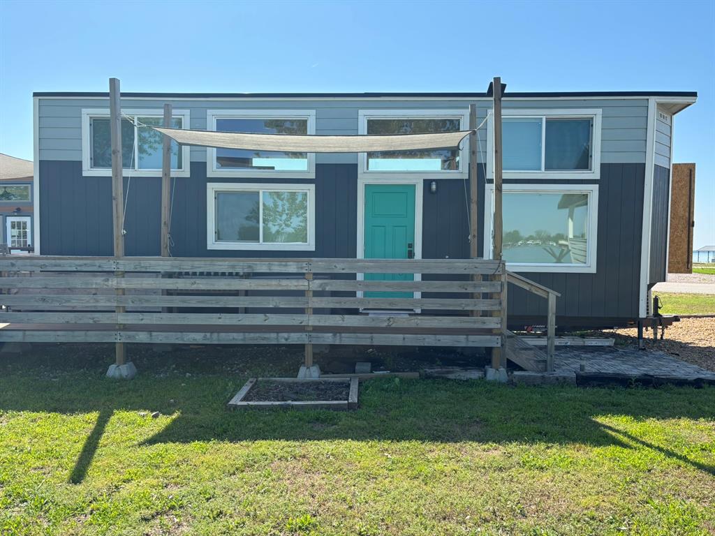 6397 Peninsula Road, Unit 132 Kerens, TX 75144 - Photo 6 of 15 a front view of a house with a yard