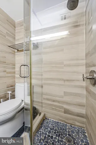 a bathroom with a toilet and a shower