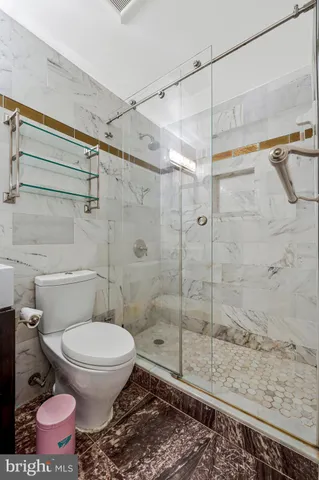 a bathroom with a shower toilet and sink