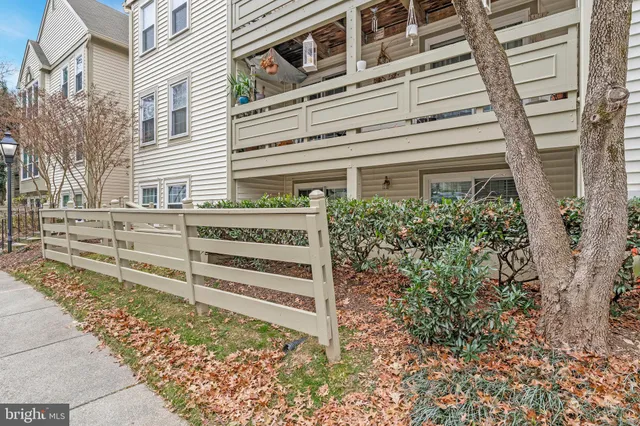 a view of a house with a window and wooden fence