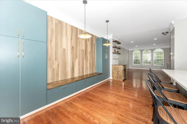 a dining room with furniture and a wooden floor