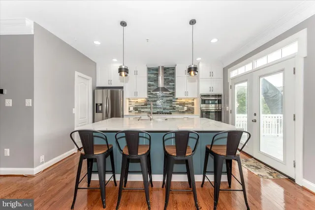 a dining room with furniture window and wooden floor