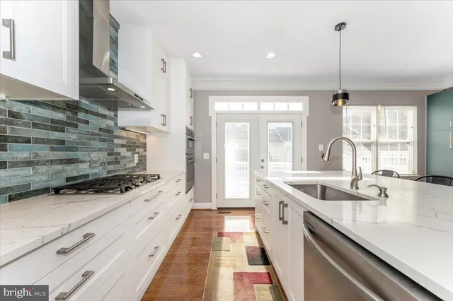 a kitchen with counter top space a sink and appliances