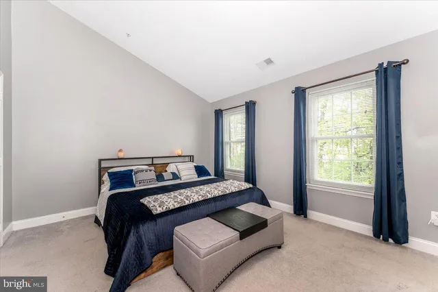 a bedroom with a bed and a couch