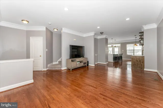 a view of a room with window wooden floor and a kitchen