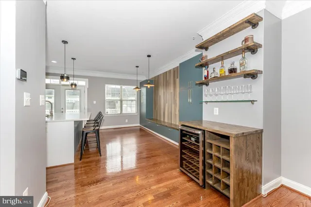 a view of a hallway with wooden floor and windows