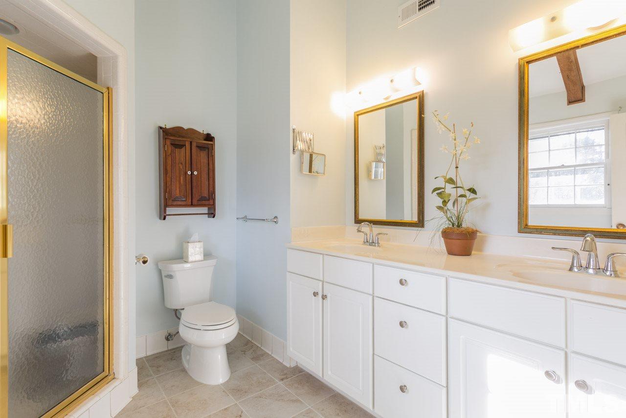 7616 Harps Mill Road Raleigh, NC 27615 - Photo 13 of 24 Double sinks, walk-in shower, and wood accent beams....so lovely!
