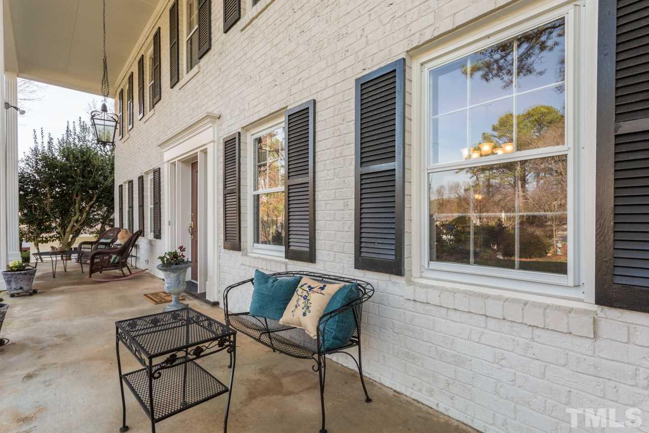 7616 Harps Mill Road Raleigh, NC 27615 - Photo 3 of 24 The front porch spans the width of the main living areas of the house.