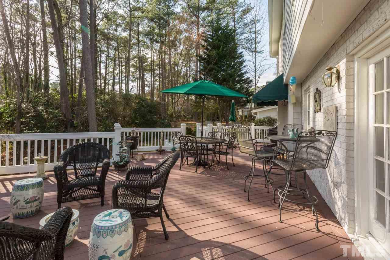 7616 Harps Mill Road Raleigh, NC 27615 - Photo 22 of 24 The deck runs behind the family room and the kitchen and overlooks the gorgeous backyard.