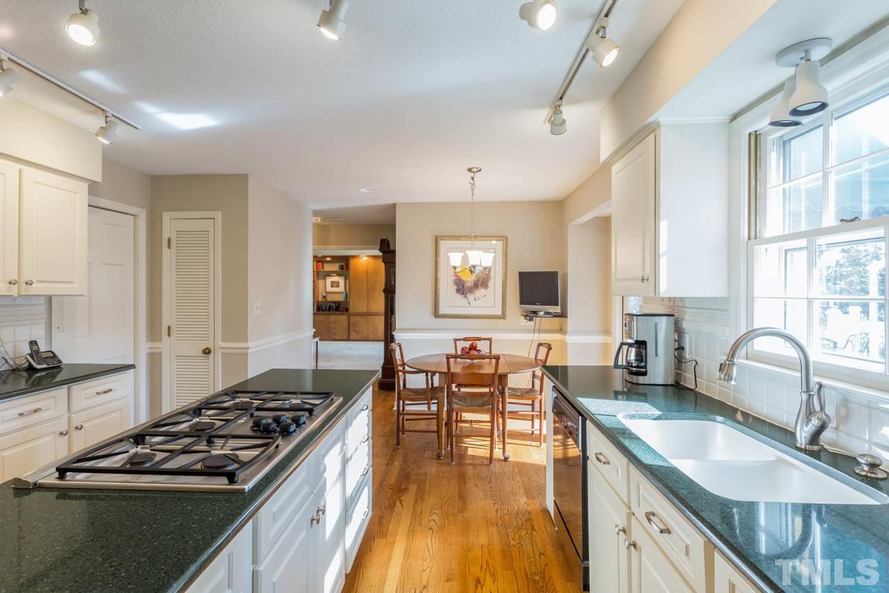 7616 Harps Mill Road Raleigh, NC 27615 - Photo 10 of 24 New brushed nickel light fixture and hardwood floors.
