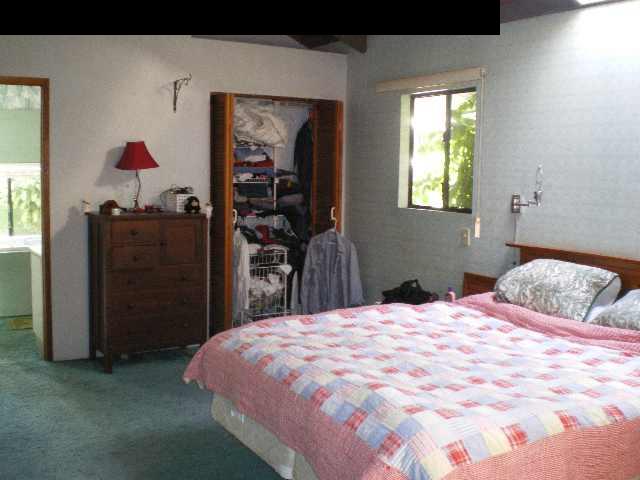 755 Haiku Road Haiku, HI 96708 - Photo 8 of 19 a bedroom with a bed and a dresser