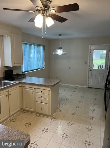a kitchen with a cabinets and chandelier