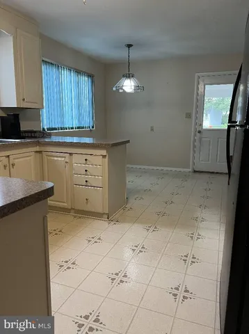 a kitchen with a stove a sink and cabinets