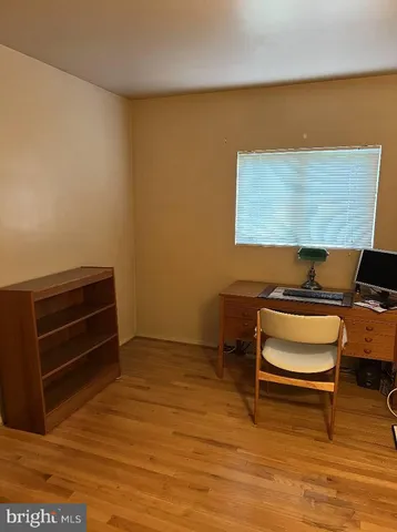 a room with wooden floor and furniture