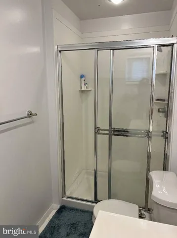 a bathroom with a shower and toilet