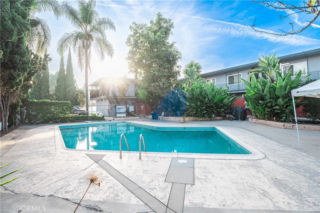 7348 Florence Avenue, Unit 4 Downey, CA 90240 - Photo 11 of 16 a swimming pool with outdoor seating and yard