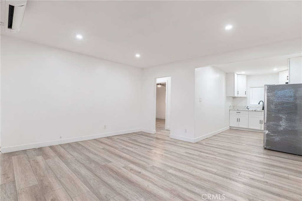 7348 Florence Avenue, Unit 4 Downey, CA 90240 - Photo 2 of 16 a view of empty room with wooden floor and electronic appliances
