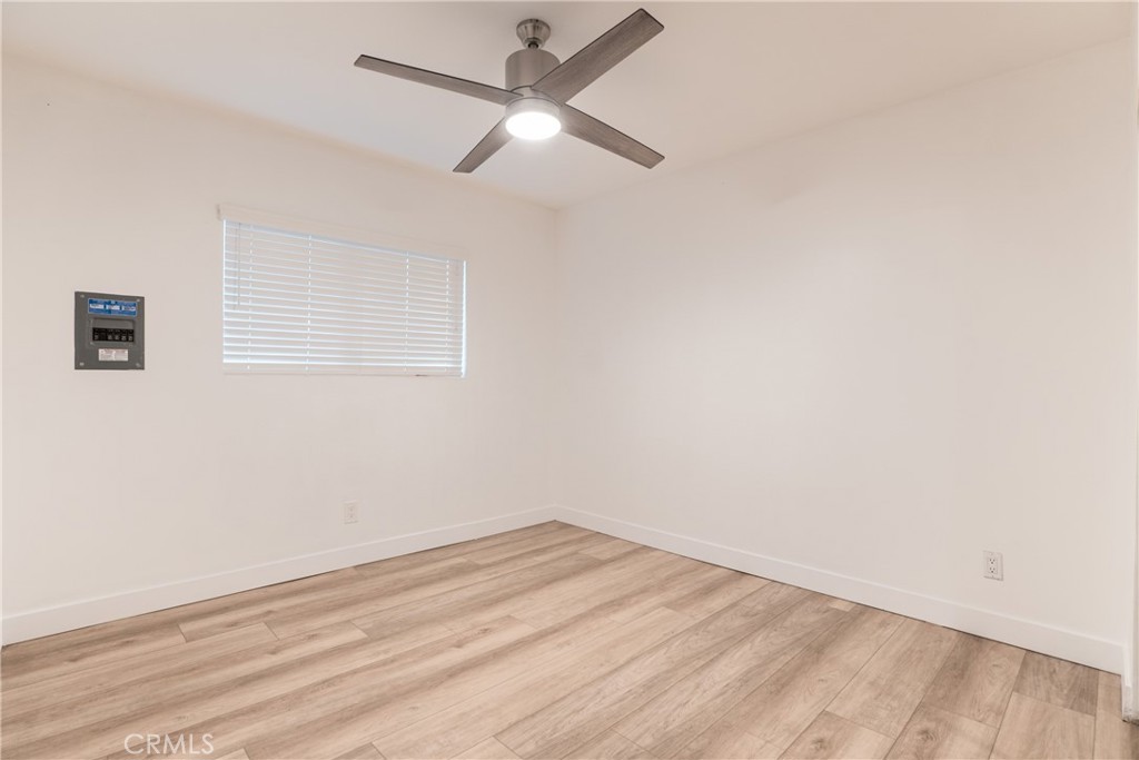7348 Florence Avenue, Unit 4 Downey, CA 90240 - Photo 8 of 16 an empty room with a window and ceiling fan