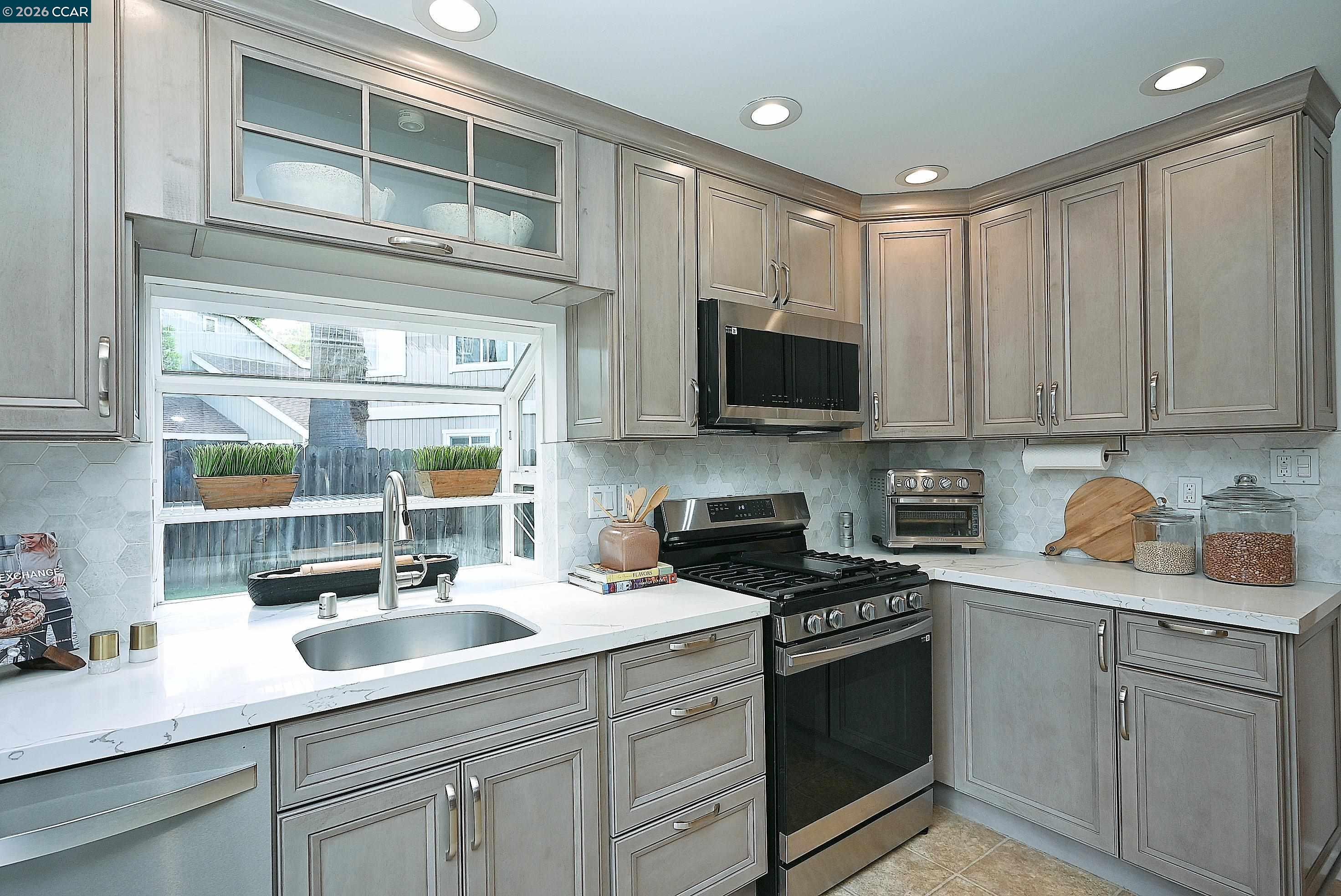 4284 Dubhe Court Concord, CA 94521 - Photo 17 of 46 a kitchen with stainless steel appliances granite countertop a sink a stove and cabinets