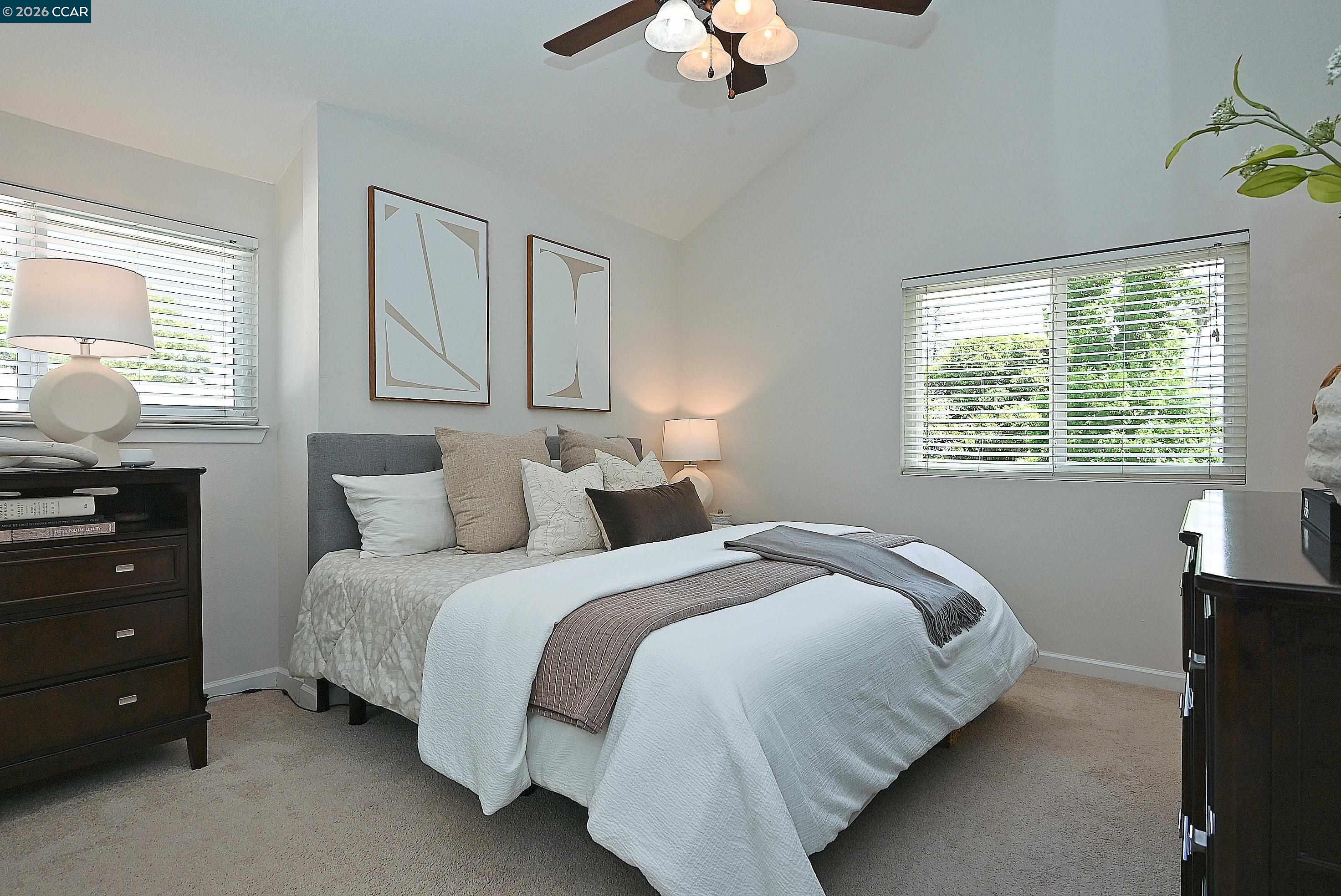 4284 Dubhe Court Concord, CA 94521 - Photo 27 of 46 a bedroom with a bed and a chandelier