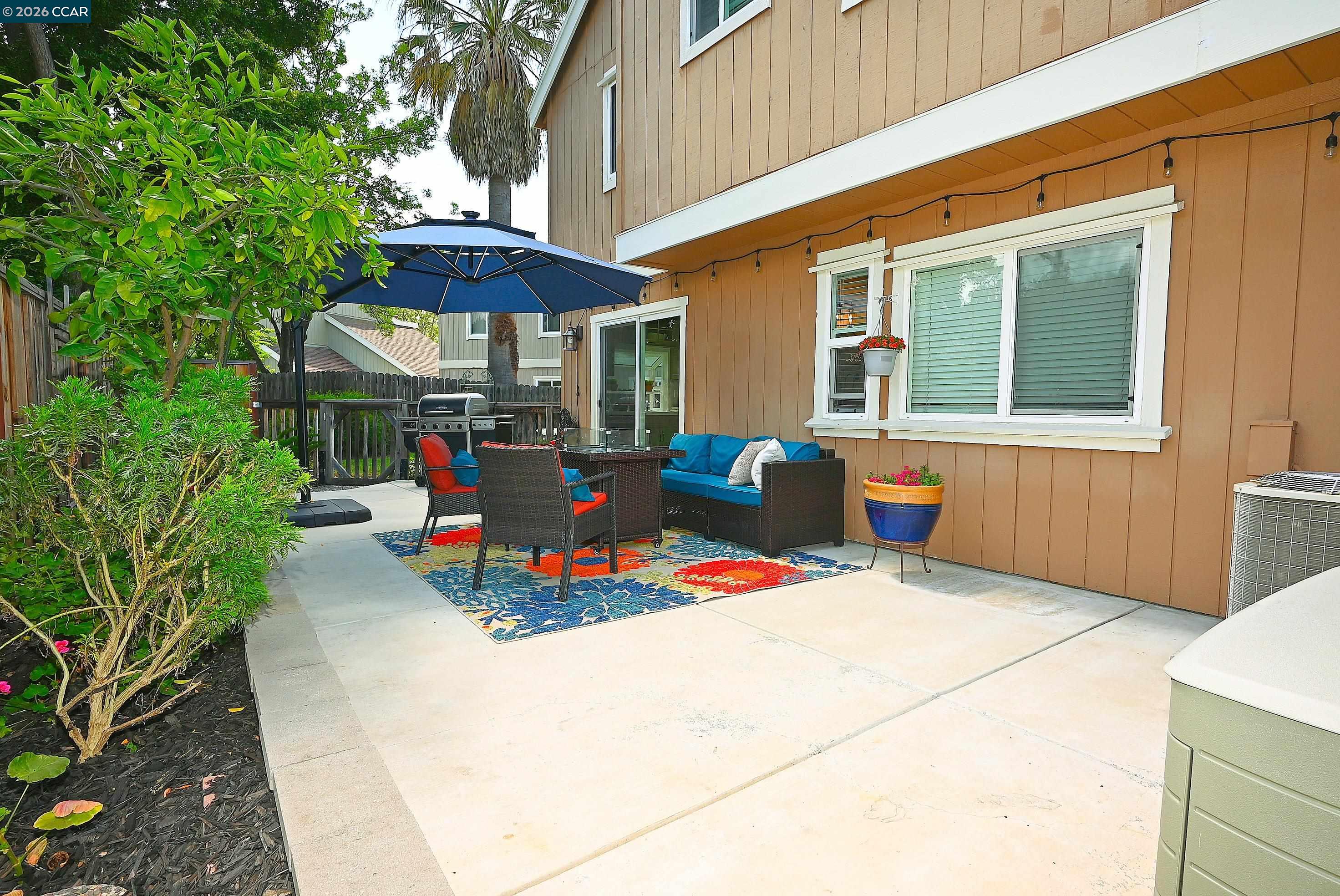 4284 Dubhe Court Concord, CA 94521 - Photo 34 of 46 a view of a patio with a table and chairs under an umbrella