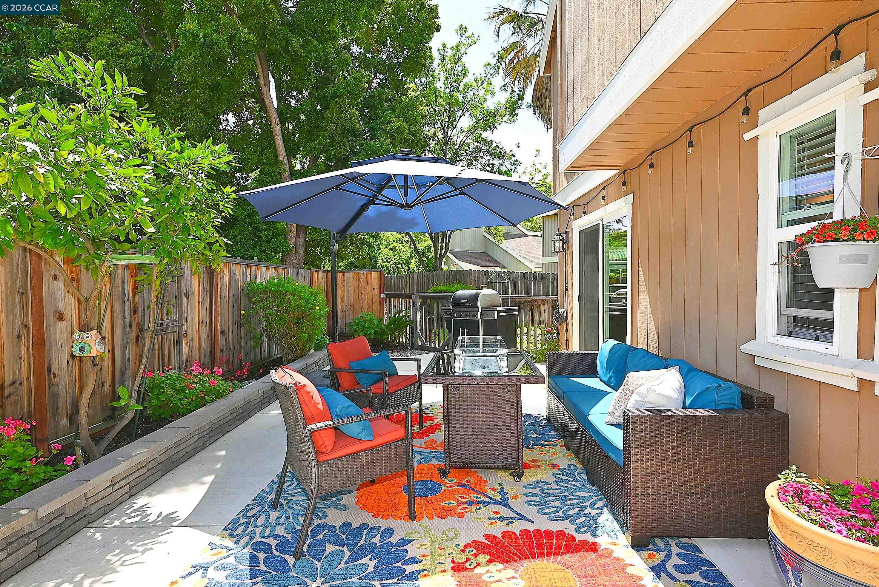 4284 Dubhe Court Concord, CA 94521 - Photo 36 of 46 a backyard of a house with table and chairs under an umbrella