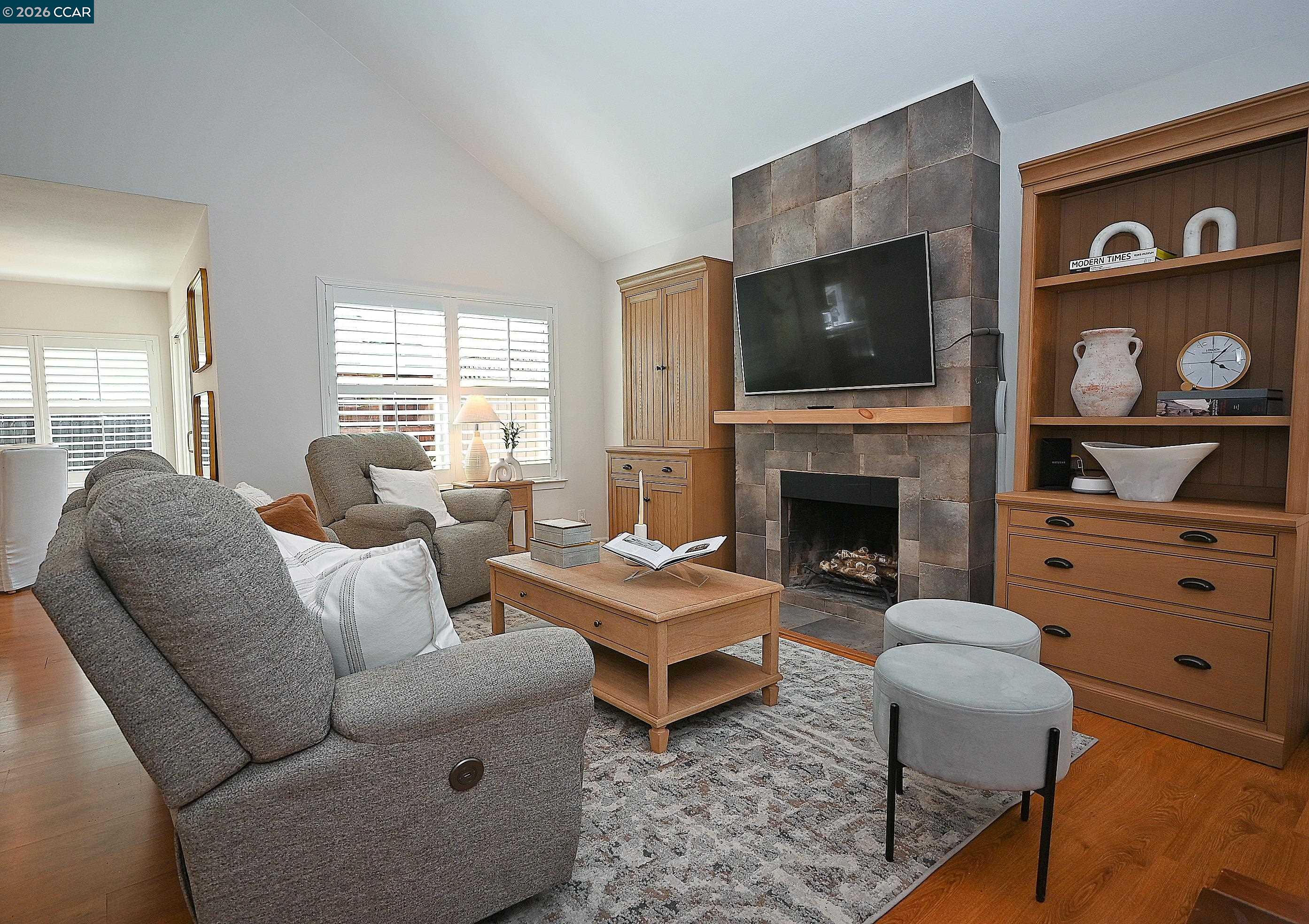 4284 Dubhe Court Concord, CA 94521 - Photo 5 of 46 a living room with furniture a flat screen tv and a fireplace