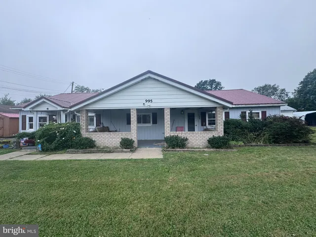 a front view of a house with a yard and porch