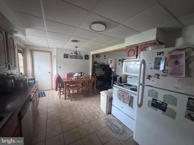 a kitchen with stainless steel appliances a stove a sink dishwasher a refrigerator and cabinets with wooden floor