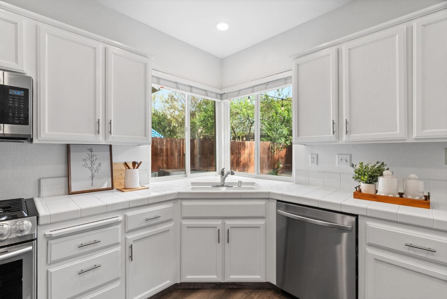 56 Lavender Court Tracy, CA 95376 - Photo 13 of 56 a kitchen with white cabinets and a window