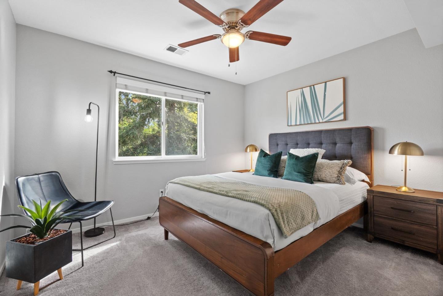 56 Lavender Court Tracy, CA 95376 - Photo 16 of 56 a bedroom with a bed and a chandelier