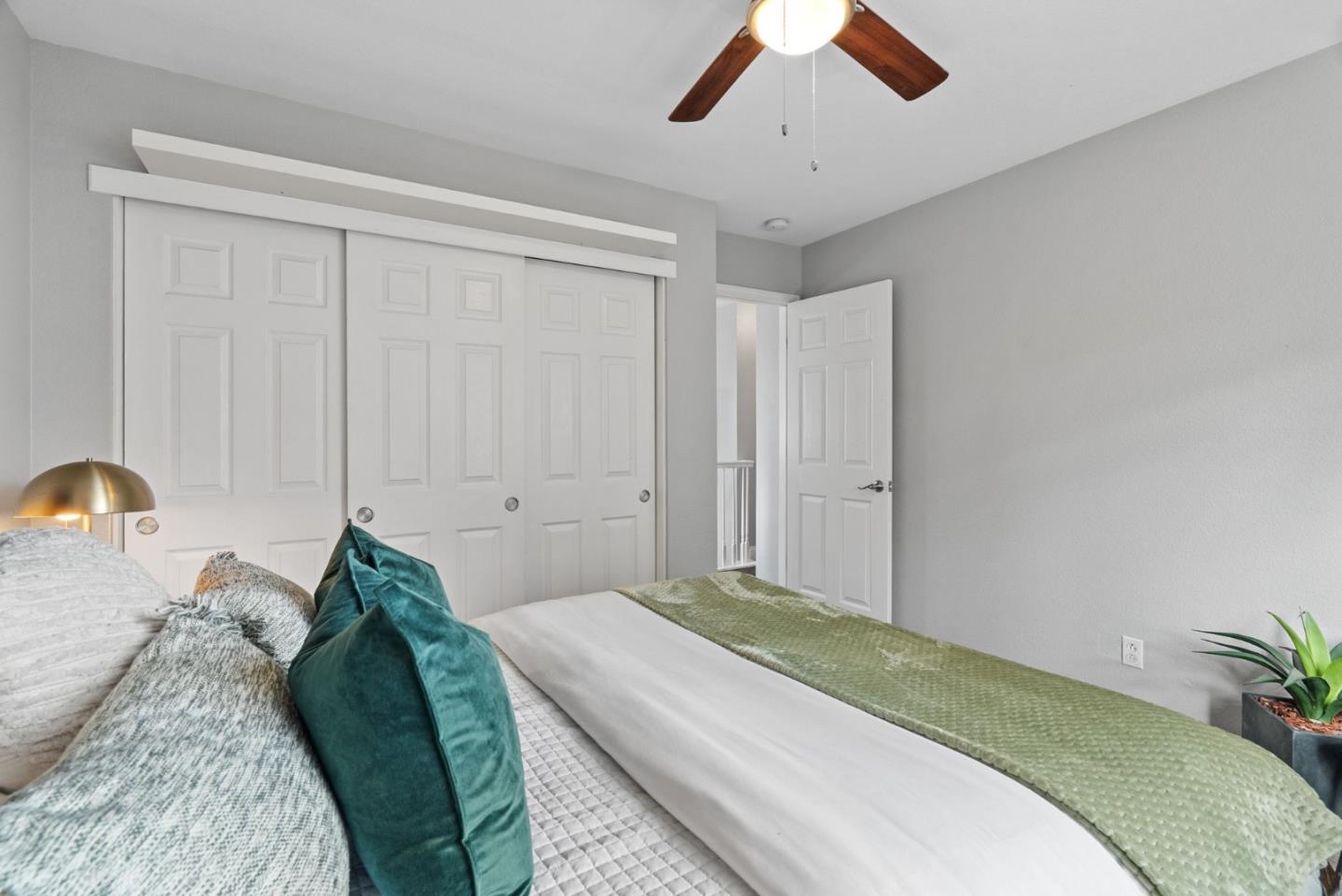 56 Lavender Court Tracy, CA 95376 - Photo 17 of 56 a bedroom with a bed and a chandelier