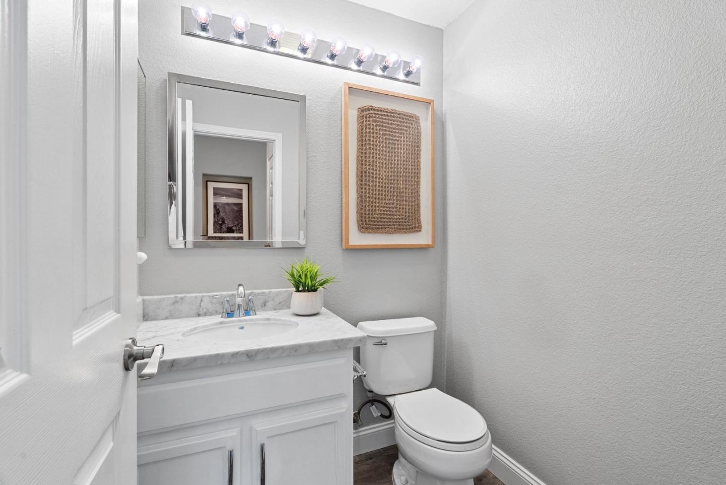 56 Lavender Court Tracy, CA 95376 - Photo 18 of 56 a bathroom with a toilet a sink and mirror