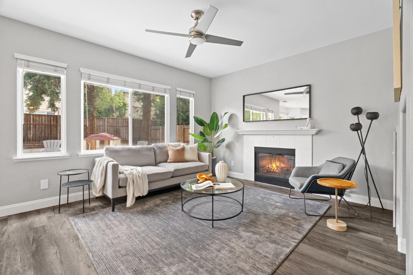 56 Lavender Court Tracy, CA 95376 - Photo 2 of 56 a living room with furniture a fireplace and a large window
