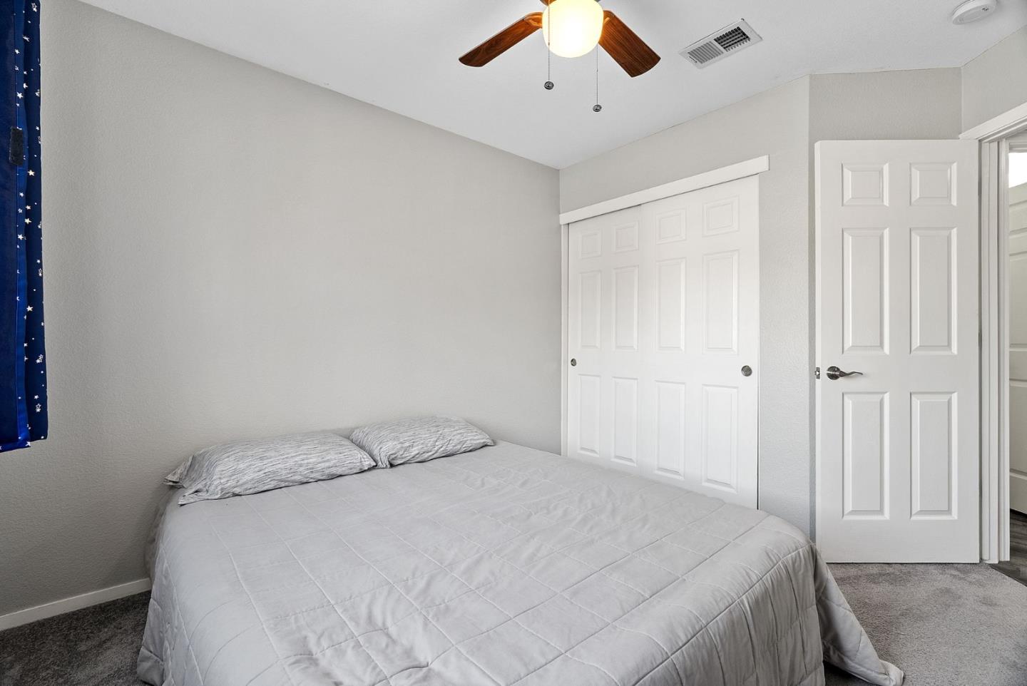 56 Lavender Court Tracy, CA 95376 - Photo 32 of 56 a bedroom with a bed and a ceiling fan