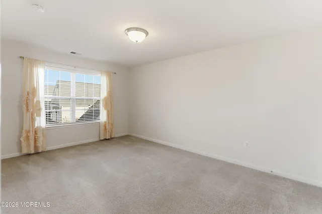 a bathroom with a bathtub shower sink vanity mirror and toilet