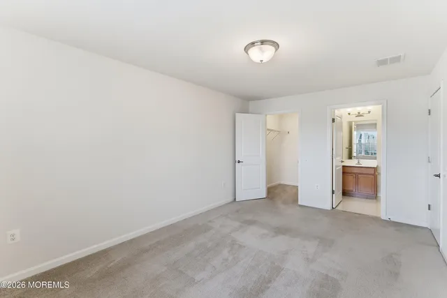 a view of a hallway with wooden floor and entryway