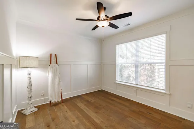 a bathroom with a granite countertop sink toilet and mirror