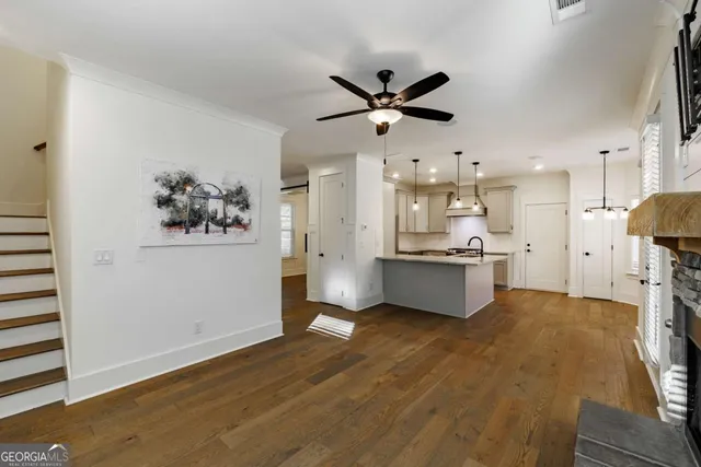 a kitchen with stainless steel appliances granite countertop a refrigerator a sink and a stove