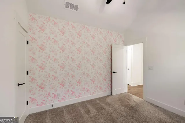 a bathroom with a granite countertop sink toilet mirror and bathtub