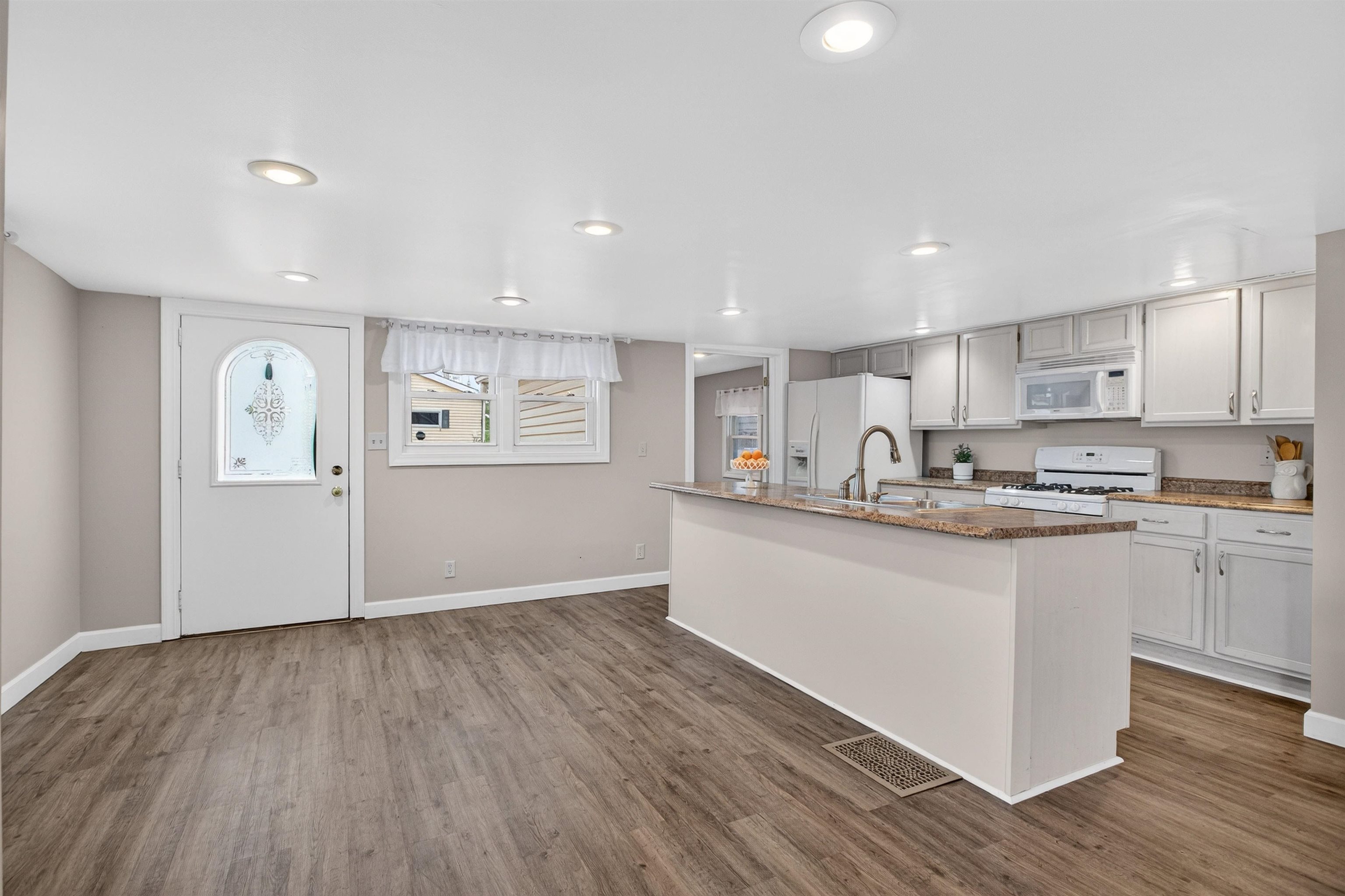 118 North Cody Road Leclaire, IA 52753 - Photo 23 of 42 a kitchen with granite countertop a stove top oven and cabinets