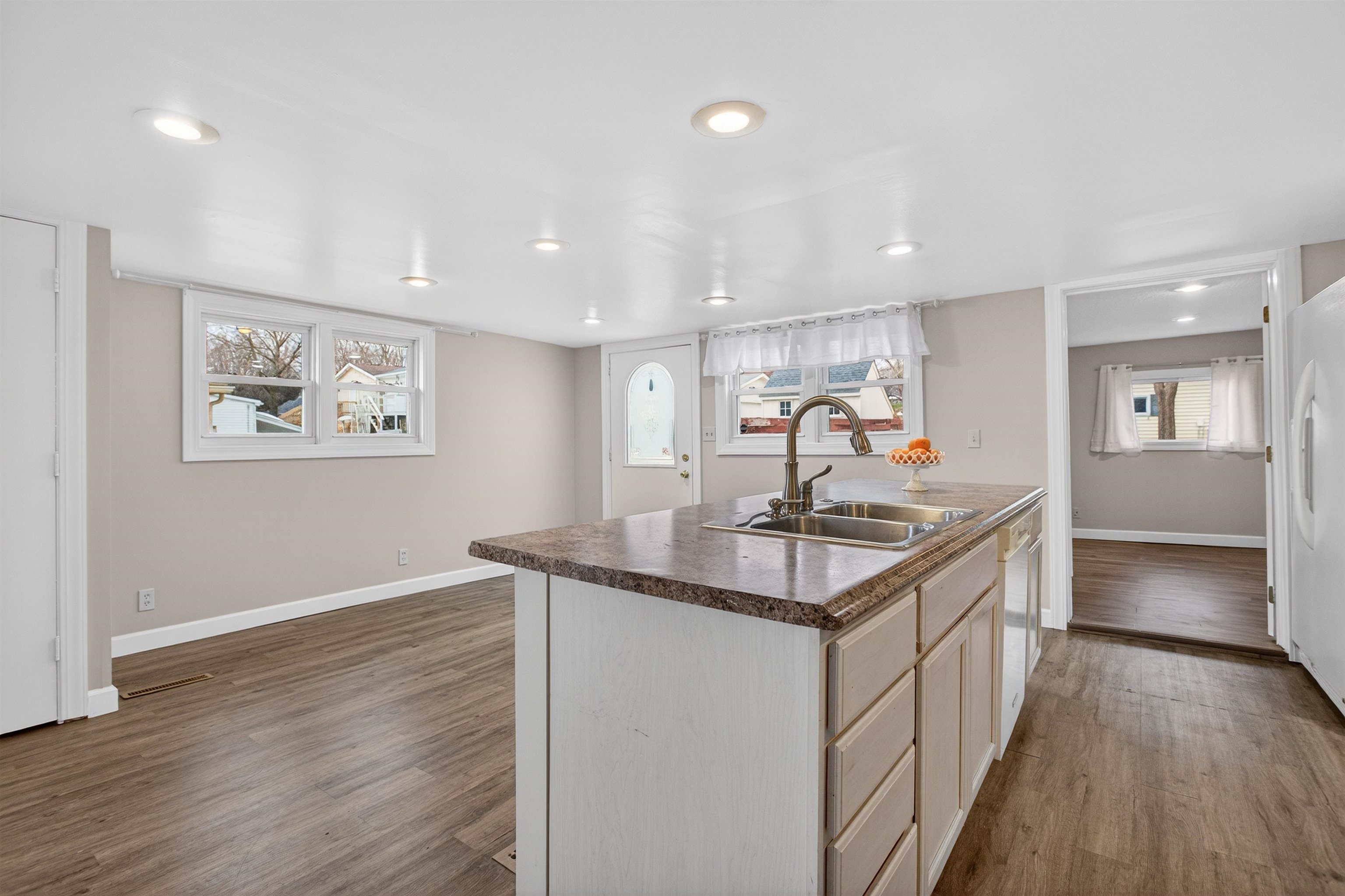 118 North Cody Road Leclaire, IA 52753 - Photo 24 of 42 a kitchen with stainless steel appliances granite countertop a sink stove and wooden floor