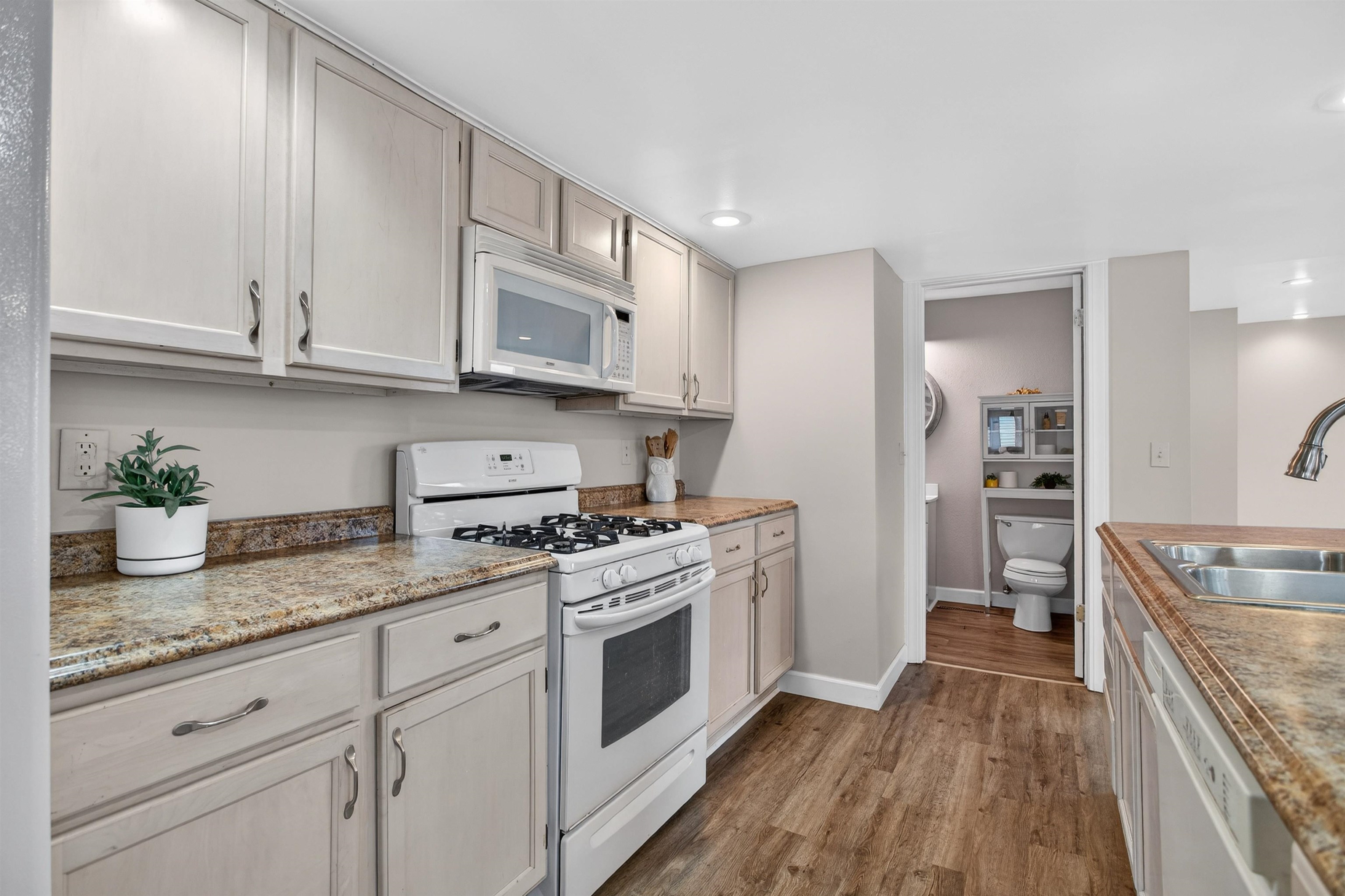 118 North Cody Road Leclaire, IA 52753 - Photo 26 of 42 a kitchen with granite countertop a sink stainless steel appliances and cabinets